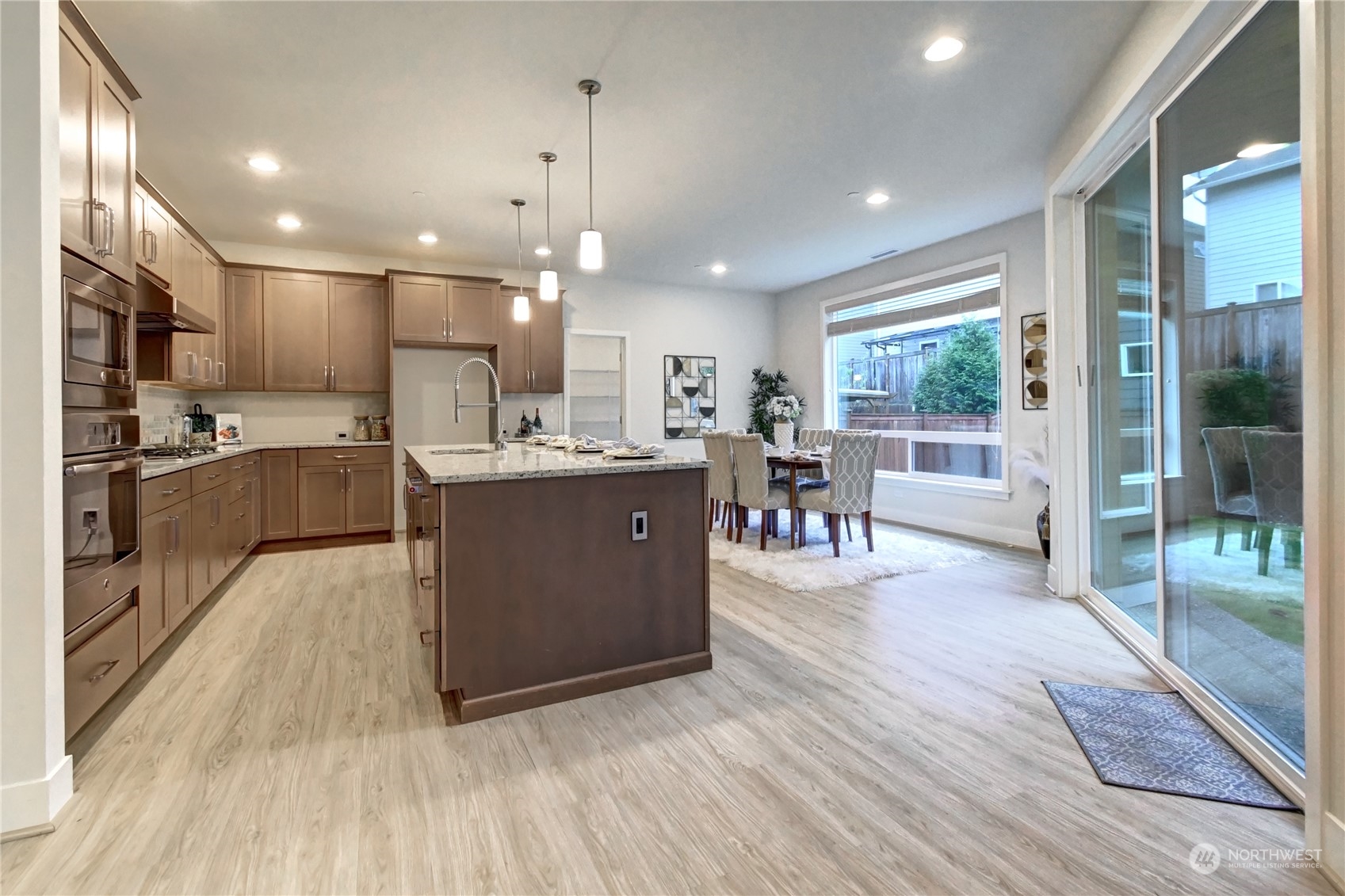 4431 231st Place Southeast Bothell, WA 98021 - Photo 6 of 36 a kitchen with stainless steel appliances kitchen island wooden cabinets and granite counter tops