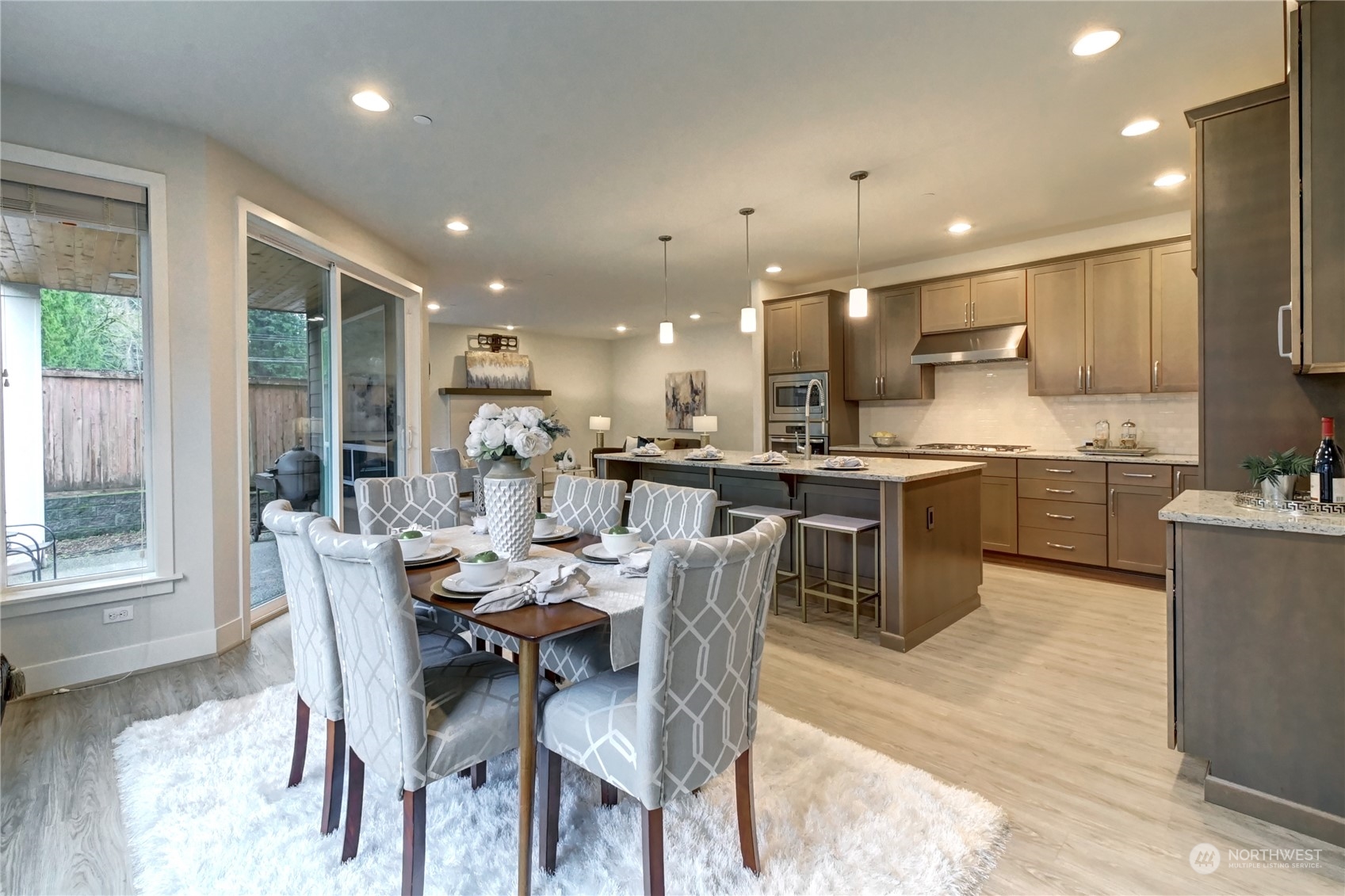 4431 231st Place Southeast Bothell, WA 98021 - Photo 9 of 36 a dining room with stainless steel appliances kitchen island granite countertop a sink a stove a dining table and chairs