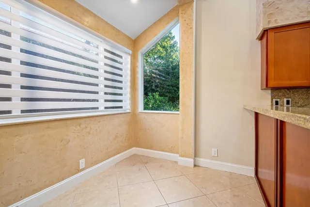 a view of a room that has a sink and a mirror