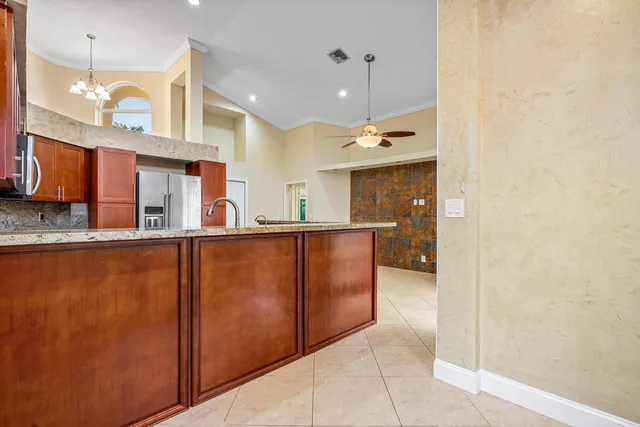 a kitchen with stainless steel appliances granite countertop a refrigerator and a sink