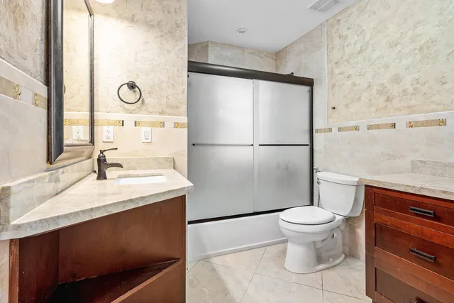 a bathroom with a sink toilet and a mirror