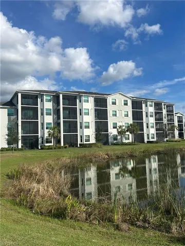 an aerial view of a house with a garden and lake view