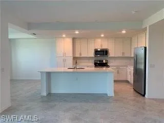 a kitchen with a sink and a large window