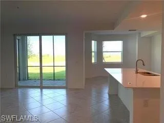 a kitchen with a refrigerator sink and cabinets