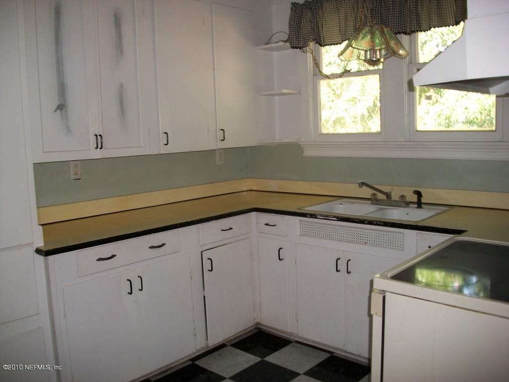 96519 Chester Road Yulee, FL 32097 - Photo 2 of 5 a utility room with cabinets washer and dryer