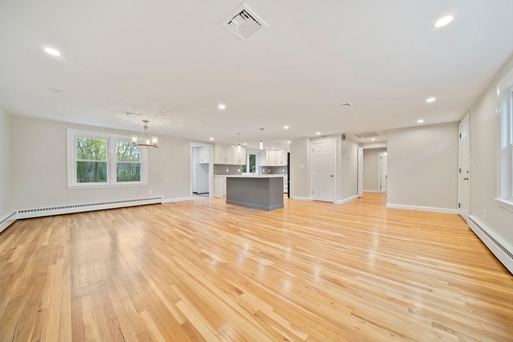 26 Leonard Road Sharon, MA 02067 - Photo 3 of 25 a view of an empty room with wooden floor and a window