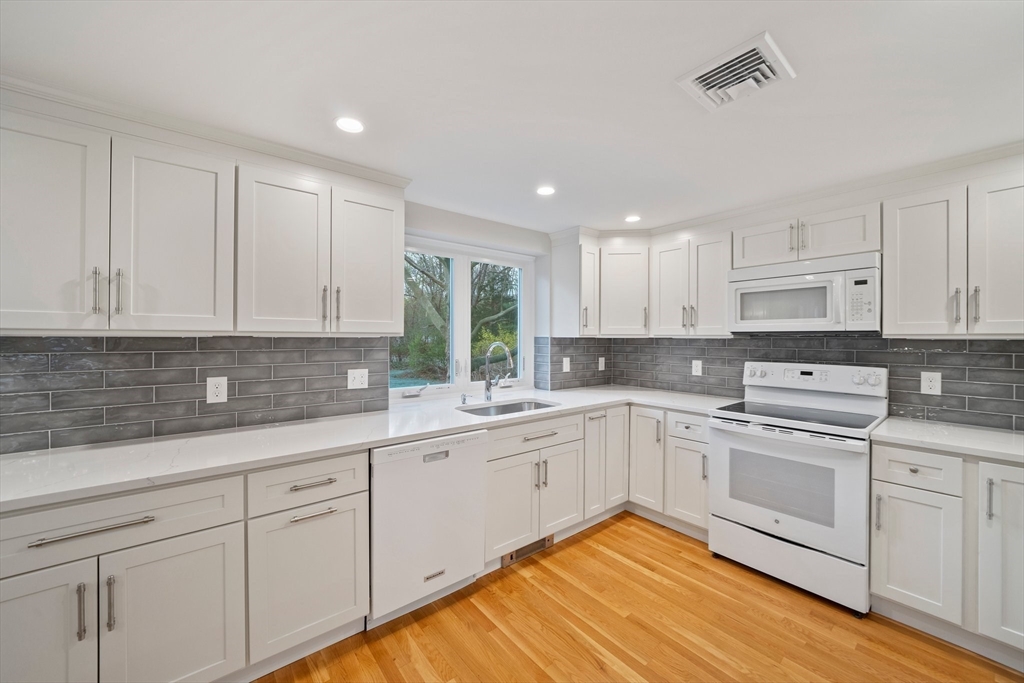 26 Leonard Road Sharon, MA 02067 - Photo 7 of 25 a kitchen with white cabinets appliances and a sink