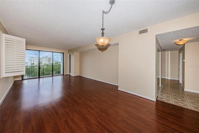 a view of empty room with wooden floor