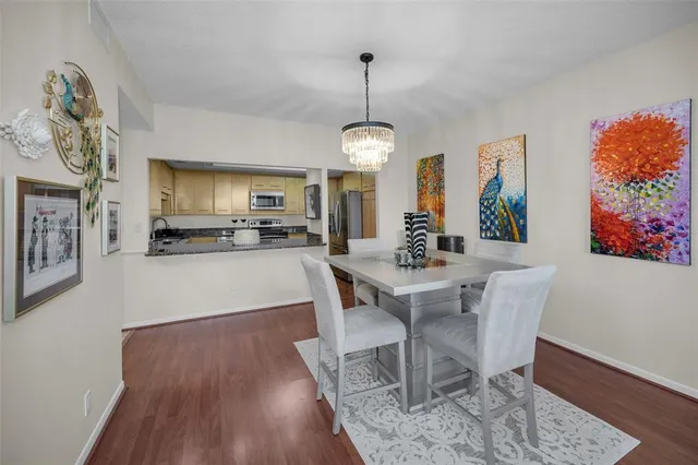 a bedroom with a bed and a flat tv screen on the dresser