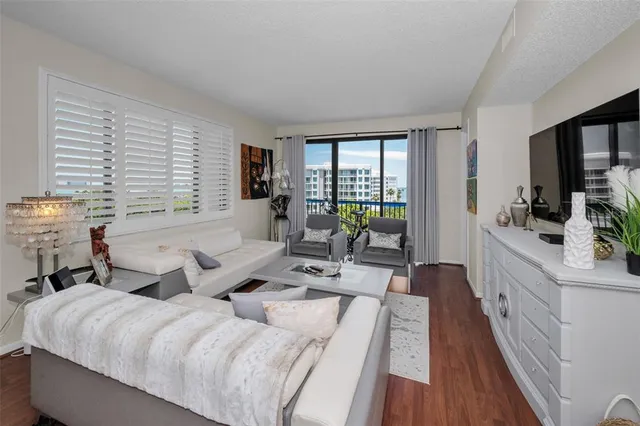 a spacious bedroom with a bed and a lamp