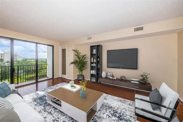 a living room with furniture wooden floor and a rug