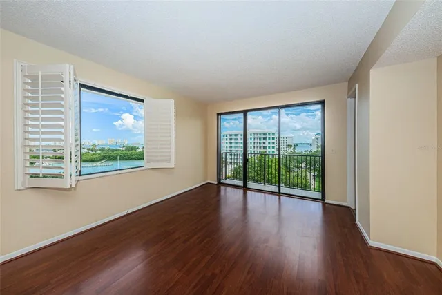 a kitchen with a refrigerator a sink and wooden floor