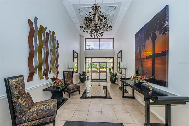 a living room with furniture a large window and a chandelier