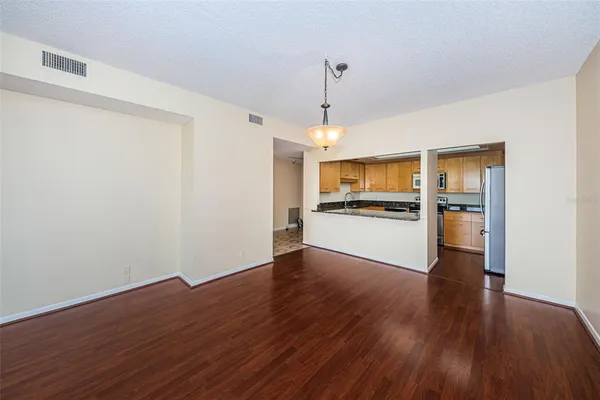 a kitchen with granite countertop a refrigerator and a sink