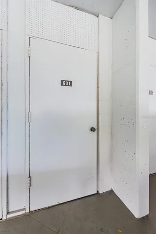 a view of a kitchen with white cabinets