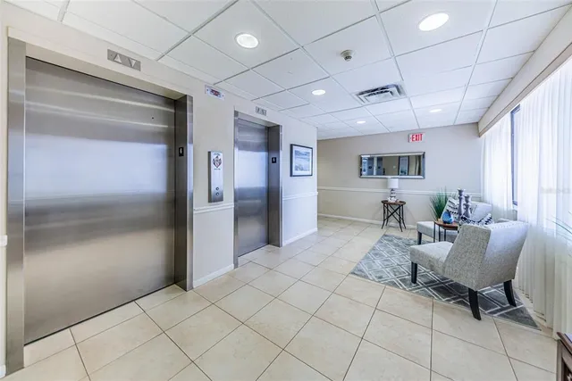 a view of a bedroom with cabinet and mirror