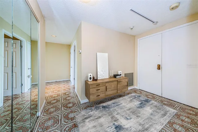 a view of a kitchen with wooden floor and a ceiling fan