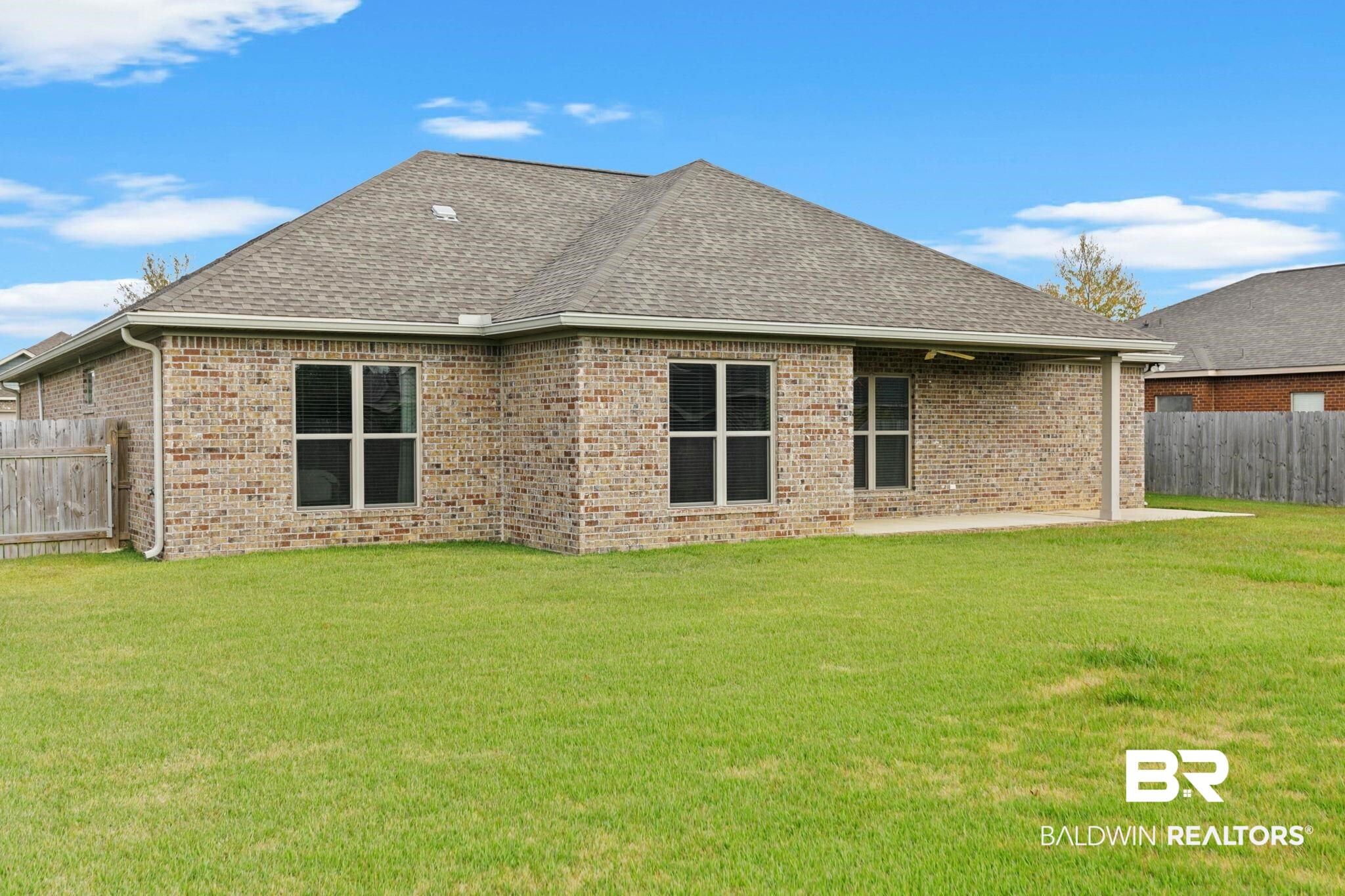 9388 Pembrook Loop Fairhope, AL 36532 - Photo 49 of 53 Back of property with brick siding, a patio area, and roof with shingles