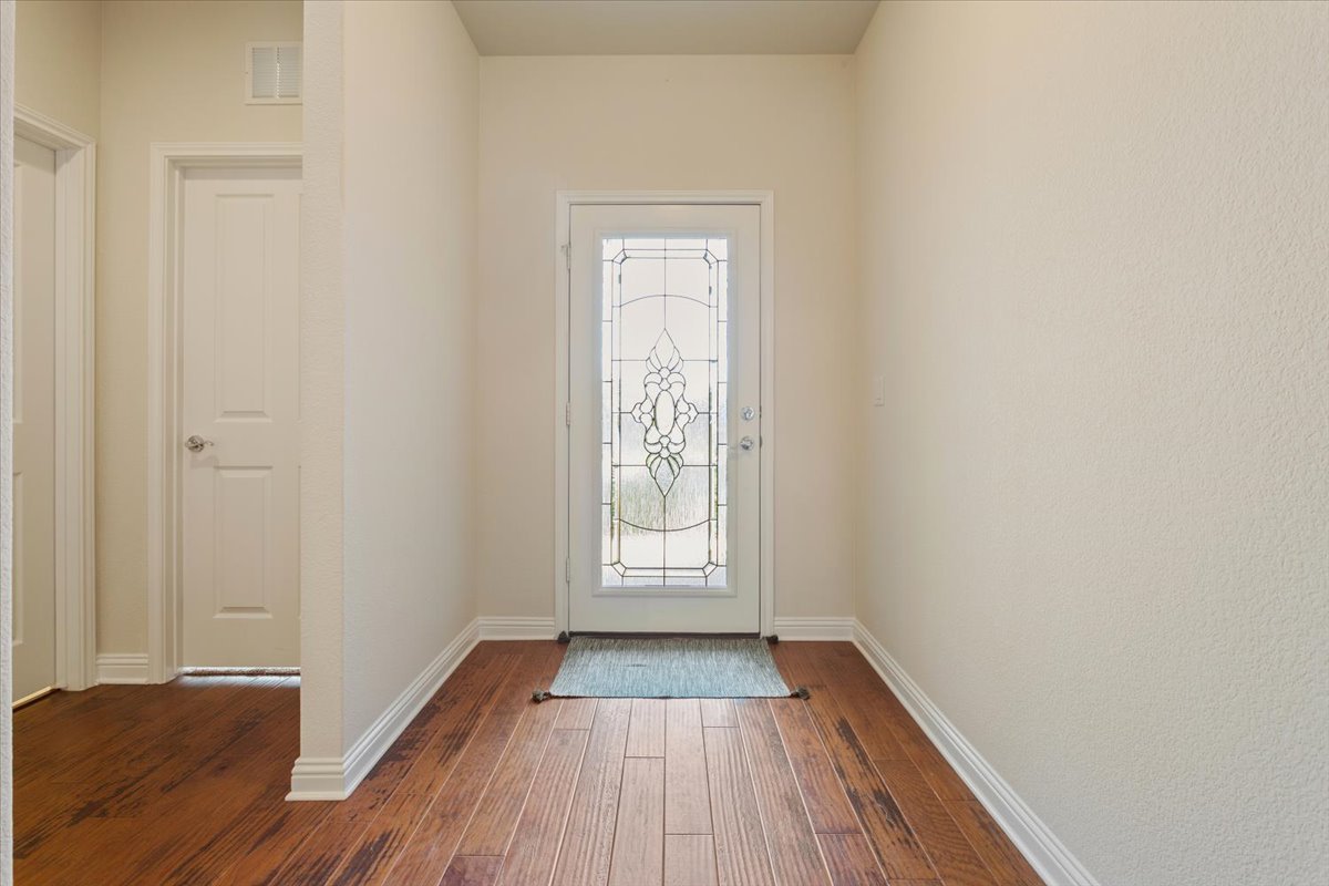 108 Cathedral Mountain Pass Georgetown, TX 78633 - Photo 5 of 36 a view of an empty room with wooden floor and a window