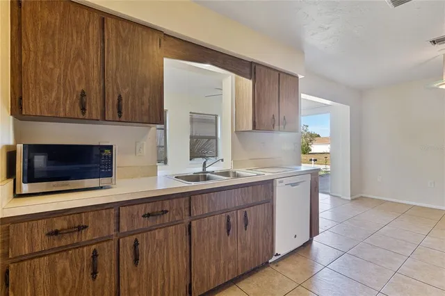 a kitchen with a stove top oven sink and cabinets