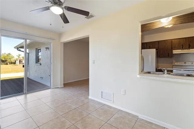 a view of a hallway with a ceiling fan