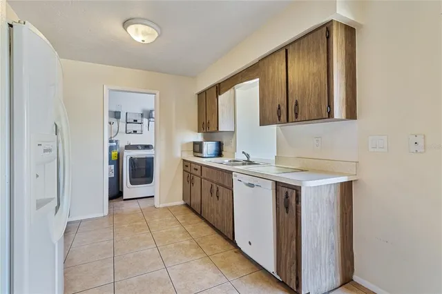 a kitchen with stainless steel appliances granite countertop a refrigerator sink and stove