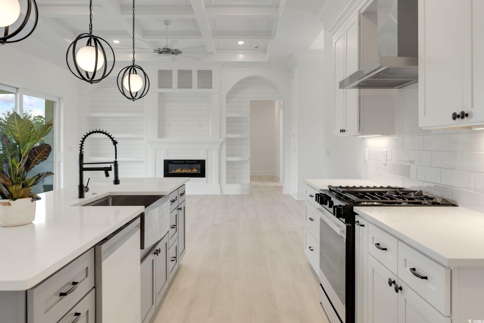 1109 Whooping Crane Drive Conway, SC 29526 - Photo 12 of 39 Kitchen with a kitchen island with sink, wall chim