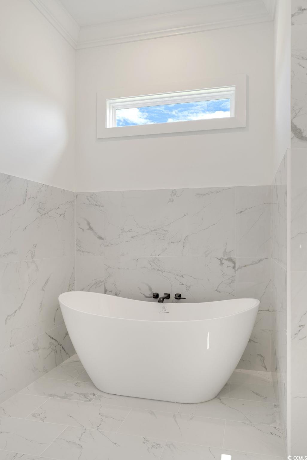1109 Whooping Crane Drive Conway, SC 29526 - Photo 21 of 39 Bathroom featuring a bath, tile walls, and plenty