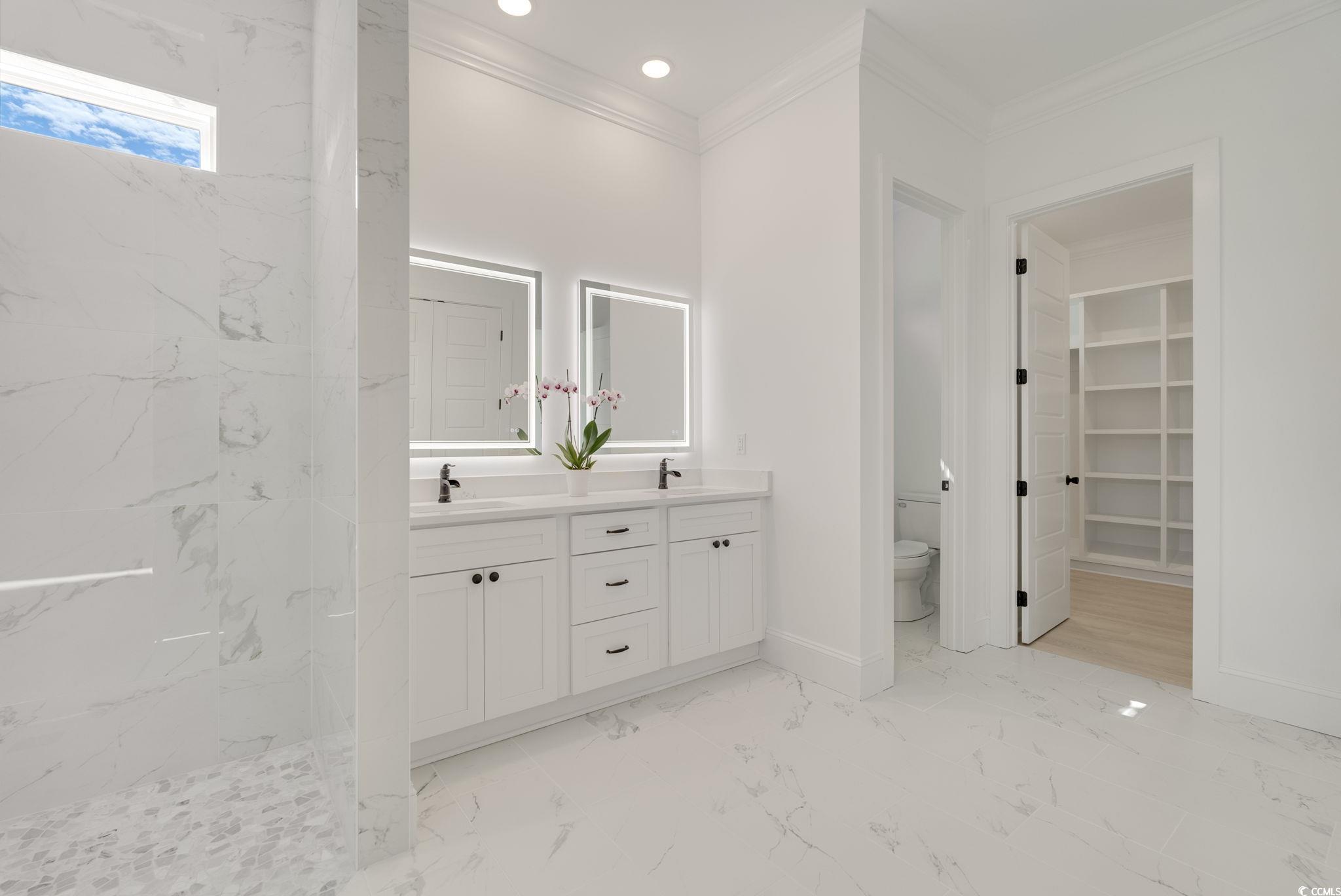 1109 Whooping Crane Drive Conway, SC 29526 - Photo 22 of 39 Bathroom with a tile shower, vanity, crown molding