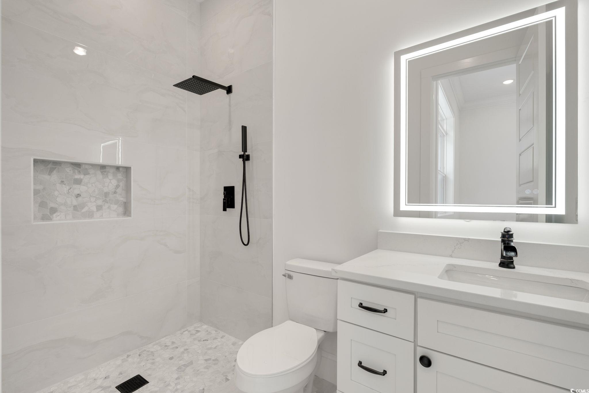 1109 Whooping Crane Drive Conway, SC 29526 - Photo 28 of 39 Bathroom with vanity, toilet, and tiled shower