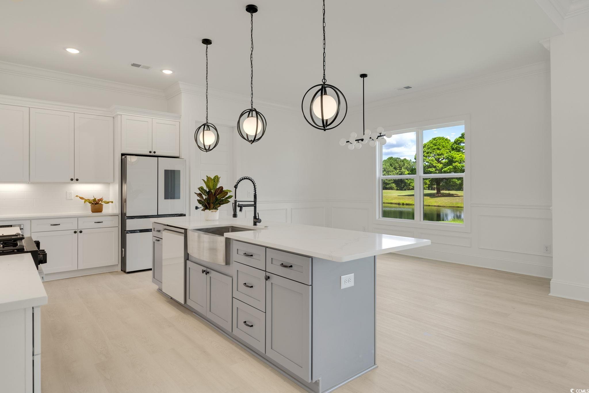 1109 Whooping Crane Drive Conway, SC 29526 - Photo 9 of 39 Kitchen featuring white cabinets, an island with s