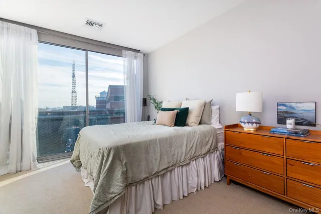 a bedroom with bed and a couch