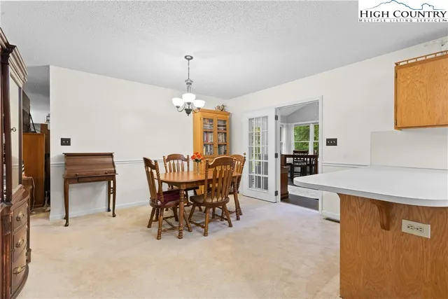 a view of a dining room with furniture and chandelier