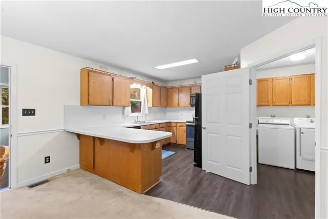 a kitchen with white cabinets and sink