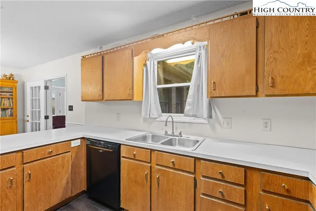 a kitchen with sink and cabinets