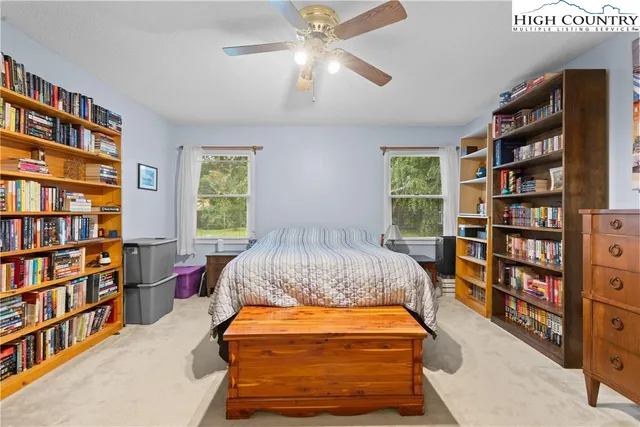 a bedroom with furniture and a book shelf