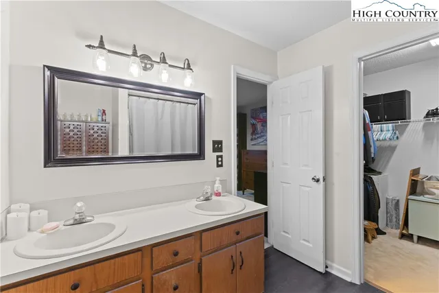 a bathroom with a sink vanity and mirror