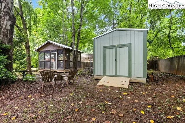 a backyard of a house with table and chairs