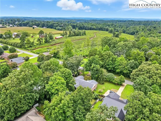 an aerial view of residential houses with outdoor space and swimming pool