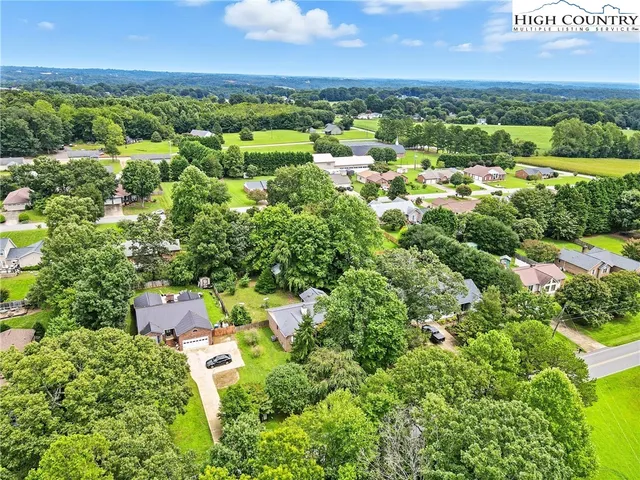 an aerial view of a houses with a yard