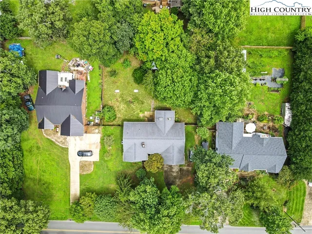 an aerial view of a house with outdoor space and a parking space