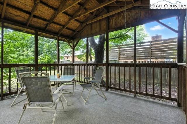 a view of a chair and table in the balcony