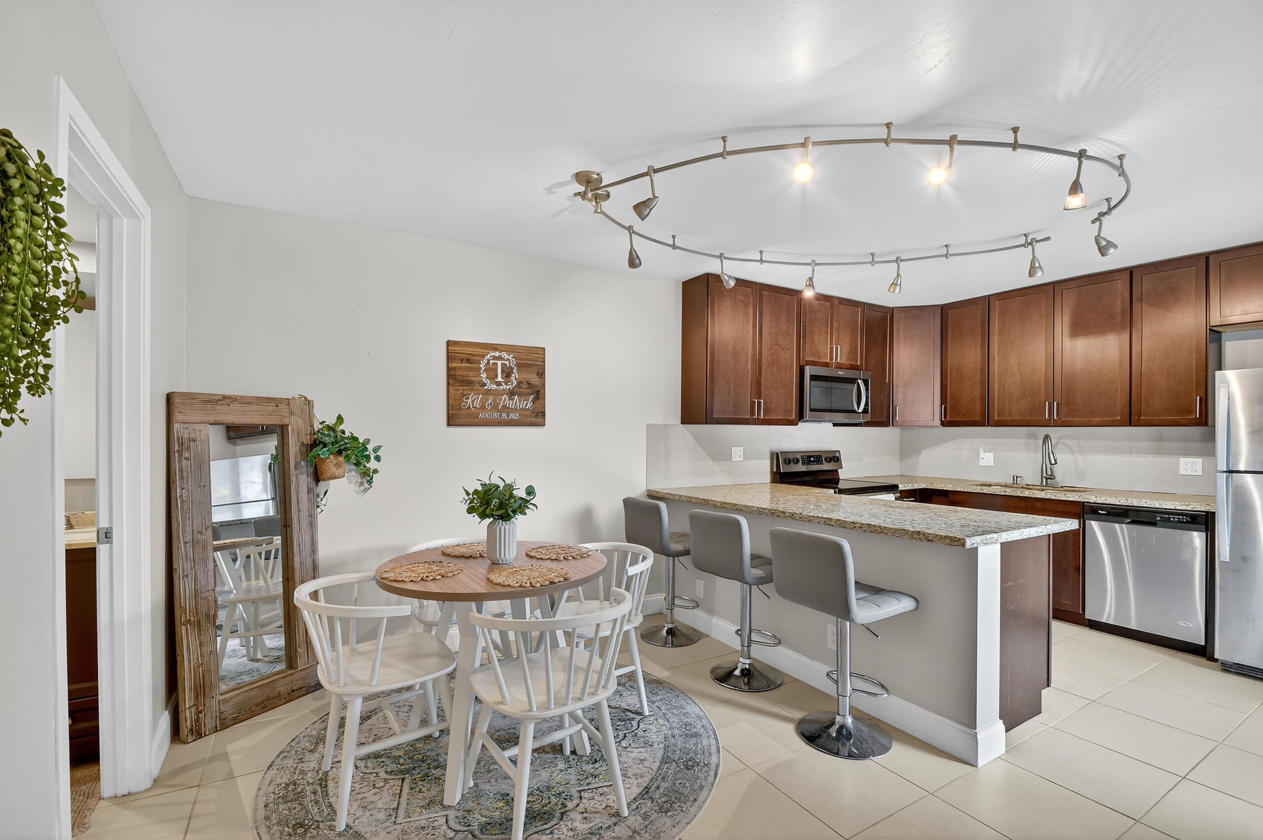 a kitchen with a dining table chairs sink and cabinets