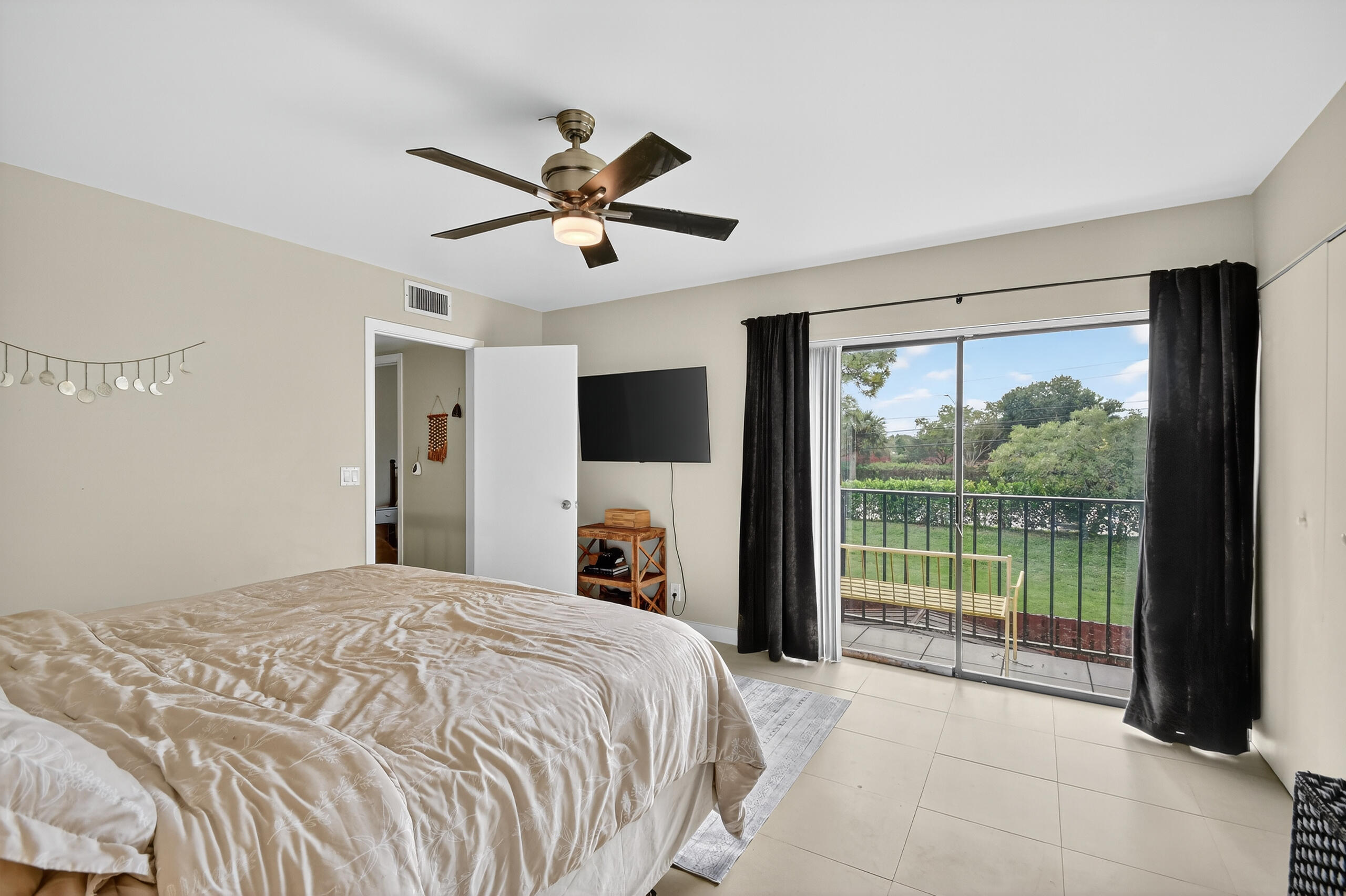 1540 Masters Circle, Unit 180 Delray Beach, FL 33445 - Photo 13 of 28 a bedroom with a large bed and a large window