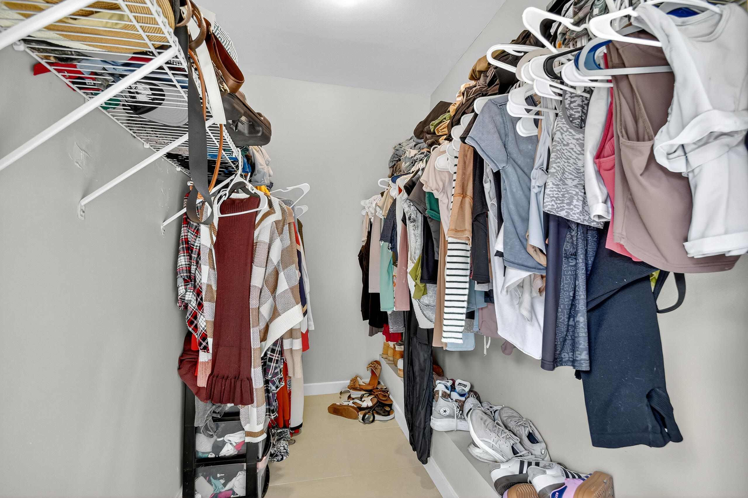 1540 Masters Circle, Unit 180 Delray Beach, FL 33445 - Photo 17 of 28 a view of walk in closet with clothes