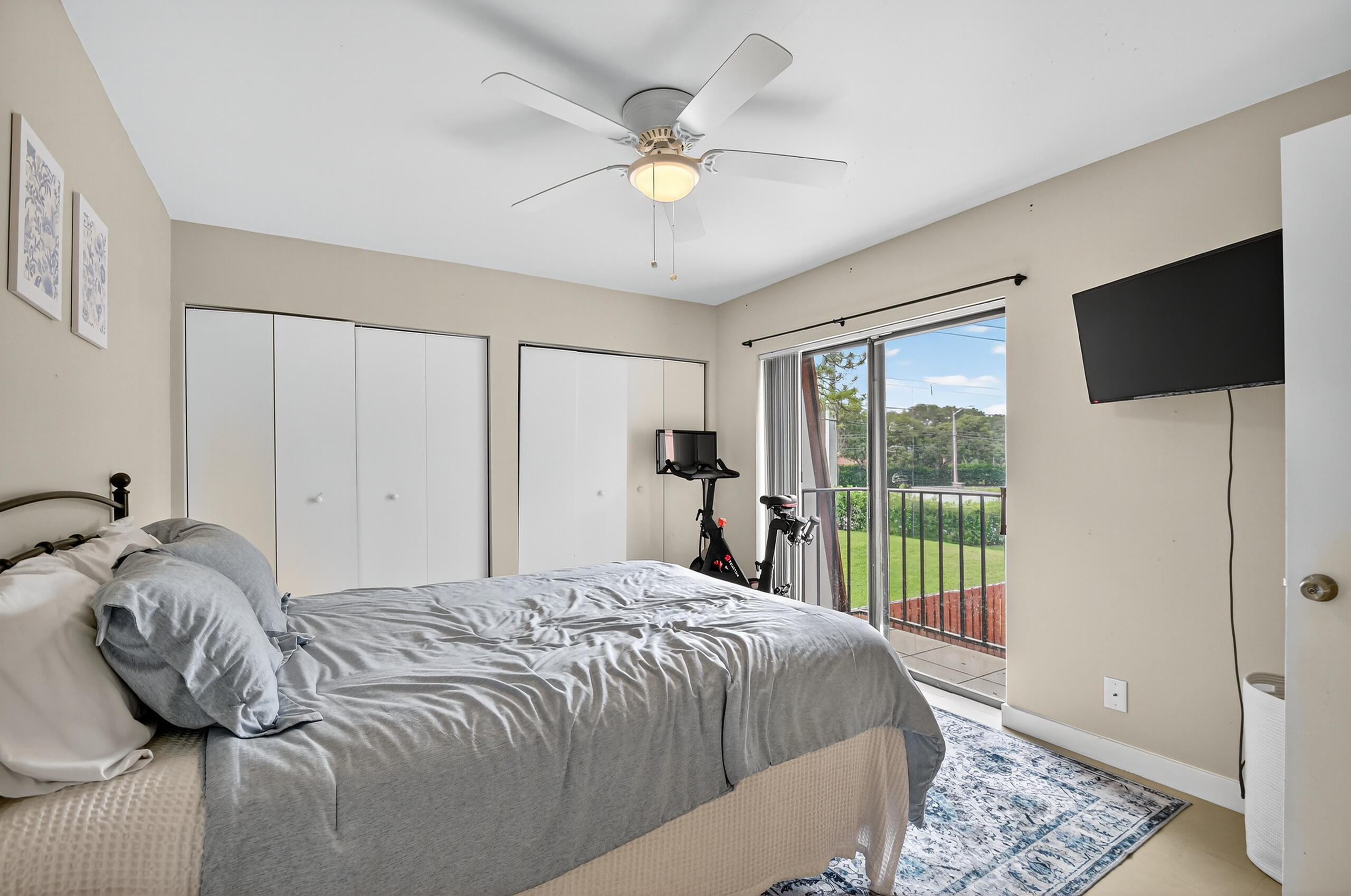 1540 Masters Circle, Unit 180 Delray Beach, FL 33445 - Photo 18 of 28 a bedroom with a bed and a large window