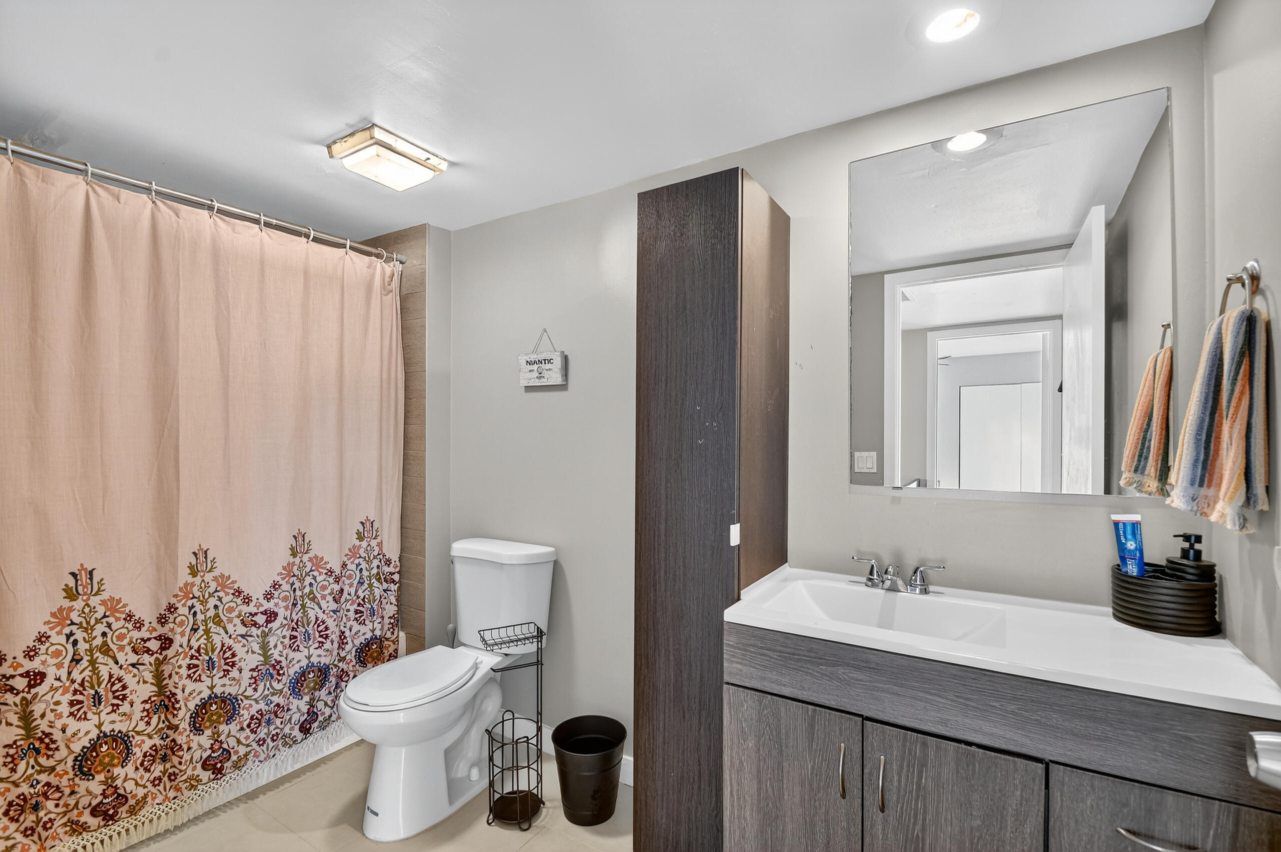 1540 Masters Circle, Unit 180 Delray Beach, FL 33445 - Photo 19 of 28 a bathroom with a granite countertop sink toilet and mirror