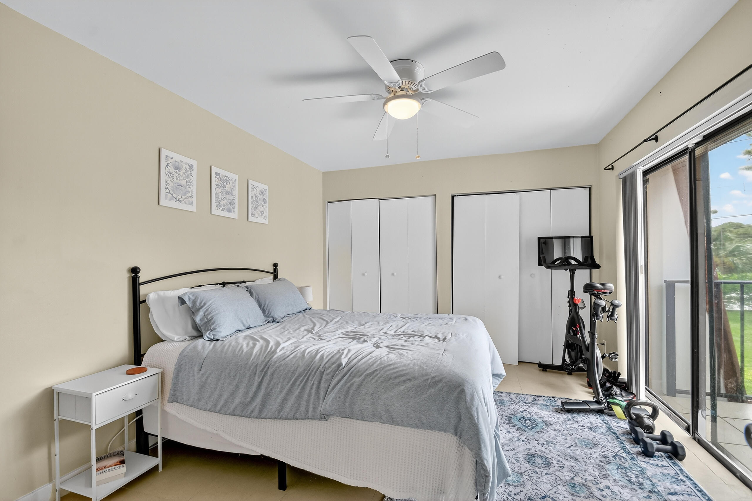 1540 Masters Circle, Unit 180 Delray Beach, FL 33445 - Photo 20 of 28 a bedroom with a bed and a chandelier