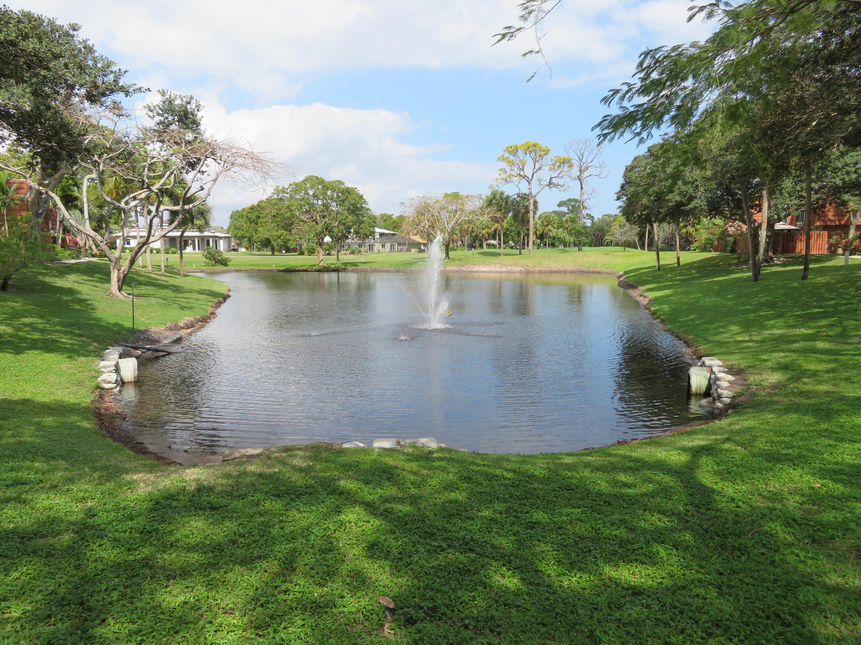 1540 Masters Circle, Unit 180 Delray Beach, FL 33445 - Photo 26 of 28 a view of a lake with a building in the background