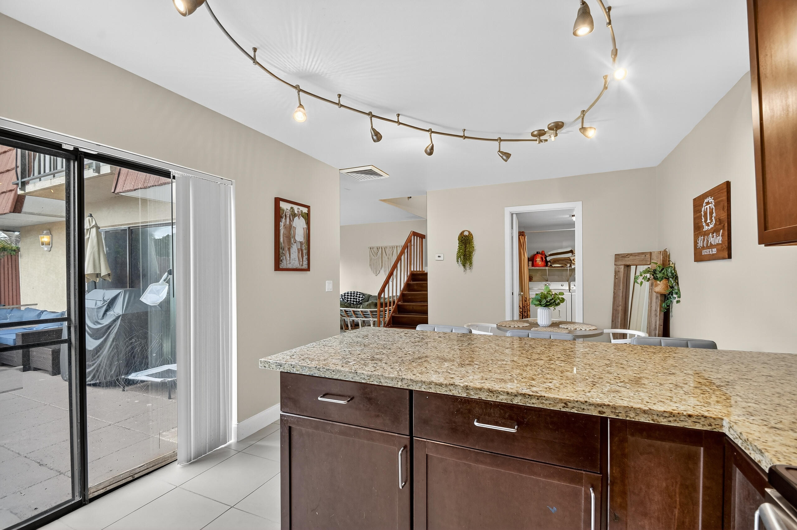 1540 Masters Circle, Unit 180 Delray Beach, FL 33445 - Photo 5 of 28 a kitchen with granite countertop cabinets and wooden floor